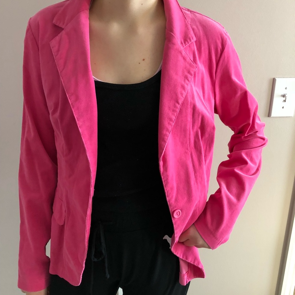 Pink blazer or jacket with corduroy texture.